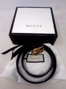 A Gucci black leather belt (waist 34)