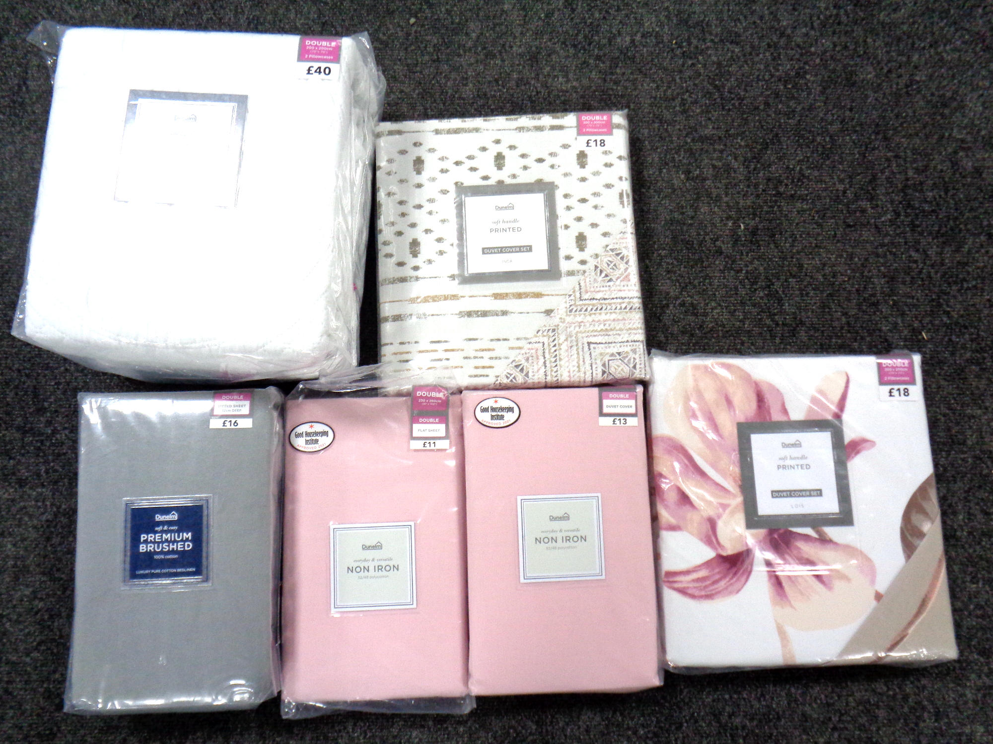 A basket of six Dunelm double duvet sets,