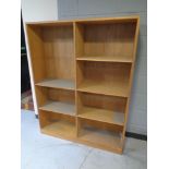 A set of teak effect open book shelves