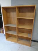 A set of teak effect open book shelves