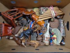 A box containing a quantity of assorted tourist carvings, Russian dolls, vintage tins,