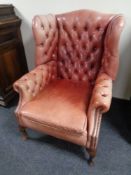 A Chesterfield buttoned leather wingback armchair