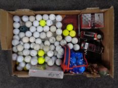 A box containing a large quantity of boxed and unboxed golf balls