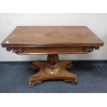 A mahogany turnover top pedestal tea table