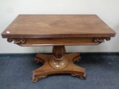 A mahogany turnover top pedestal tea table