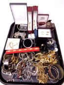 A tray containing costume jewellery, gilt metal bangles, earrings,