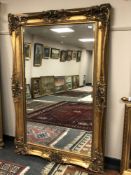 An antique style bevelled gilt mirror 123cm x 184cm CONDITION REPORT: Frame with