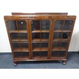 A Edwardian mahogany triple door glazed bookcase on claw and ball feet