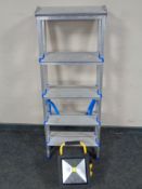 An aluminium folding twin sided step ladder together with a site light