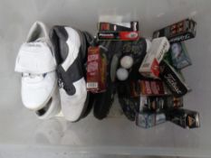 A box containing golfing shoes and golf balls
