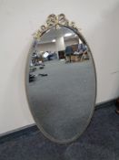 An oval gilt metal framed bevel edged mirror