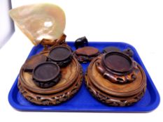 A tray containing oriental calved hardwood vase stands,