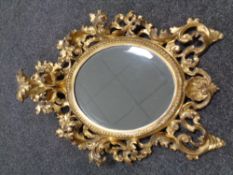 A rococo style gilt wood wall mirror 46 cm x 36 cm.