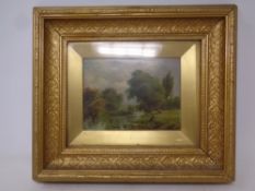 A 19th century oil painting depicting a figure sitting on a grassy bank by a river, 19.5cm by 14.