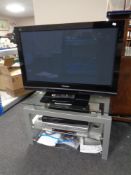 A Panasonic Viera 37" plasma TV on stand together with a Samsung DVD recorder and a Tevion DVD VCR
