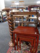 A contemporary barley twist plant stand together with a nest of three tables in a mahogany finish