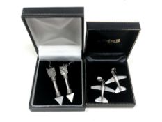 A pair of silver arrow earrings, together with a pair of similar aeroplane earrings.