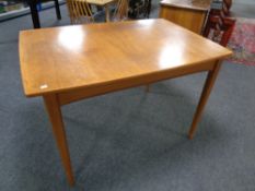 A mid 20th century rectangular extending dining table together with a pair of mid 20th century