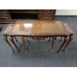 A nest of three mahogany tables on cabriole legs with plate glass tops