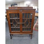 A Edwardian oak double door bookcase on raised legs