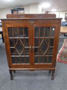 A Edwardian oak double door bookcase on raised legs