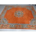 A Persian carpet on orange ground 280cmx228cm