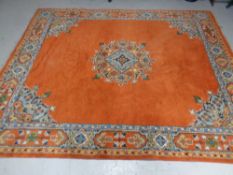 A Persian carpet on orange ground 280cmx228cm