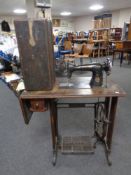 A mid 20th century Singer treadle sewing machine in oak table