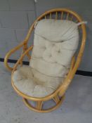 A 20th century wicker arm chair