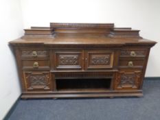 A 19th century heavily carved oak breakfront sideboard