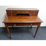A Victorian mahogany writing table fitted with nine drawers