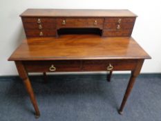 A Victorian mahogany writing table fitted with nine drawers