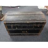 A Edwardian wooden bound dome topped shipping trunk, height 53 cm, width 76 cm, depth 47 cm.