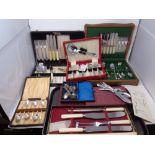 A box containing a quantity of boxed cutlery to include apostle teaspoons, carving sets, cutlery,