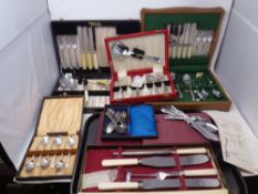 A box containing a quantity of boxed cutlery to include apostle teaspoons, carving sets, cutlery,