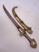 A 20th century Arabic jambiya knife in metal scabbard