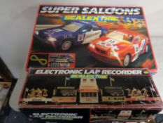 A Scalextric super saloons car racing set together with a further electronic lap recorder,