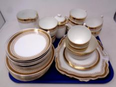 A tray of forty pieces of white and gilt Foley bone china