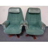 A pair of 20th century swivel armchairs upholstered in green suede and leather