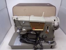 A 20th century Singer electric sewing machine in case