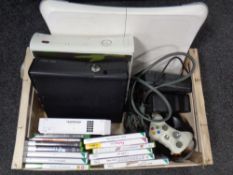A box containing 2 Xbox 360 consoles with leads and accessories,