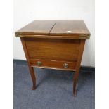 A Edwardian mahogany sewing box fitted a drawer on raised legs