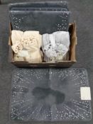 A box containing four Next Starburst bath mats together with two pompom fleece throws