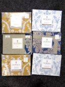 A basket of six packs of Dorma pillow cases (various patterns)