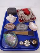 A tray of beadwork cushion, calved seashell, hand fan,