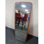 A 20th century frameless mirror mounted on a teak board