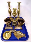 A tray of pair of brass candlesticks, further brass candlestick, pair of brass cauldrons,