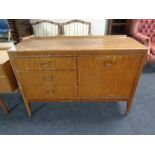 A mid 20th century mahogany cocktail sideboard fitted with three drawers