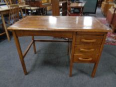 An early 20th century oak single pedestal desk fitted with three drawers