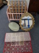 A mid 20th century dolls cot together with a wine rack, a gilt chalk framed mirror,